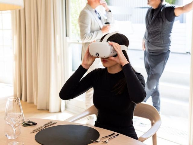 Attendee trying a VR headset at a dinner table